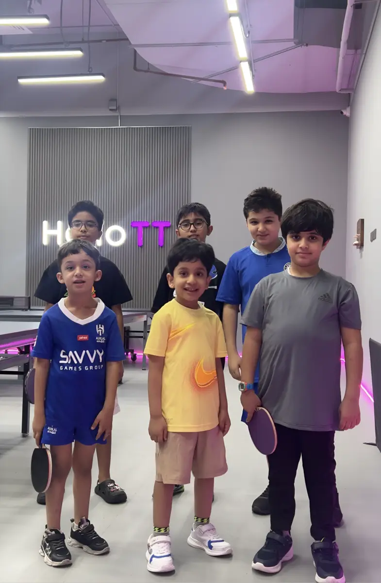 Young players posing with their bats at HelloTT