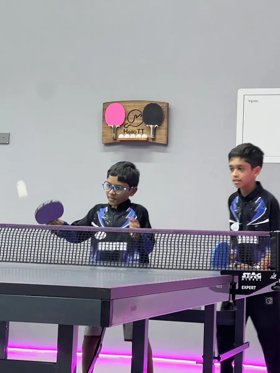 Children developing coordination through table tennis practice